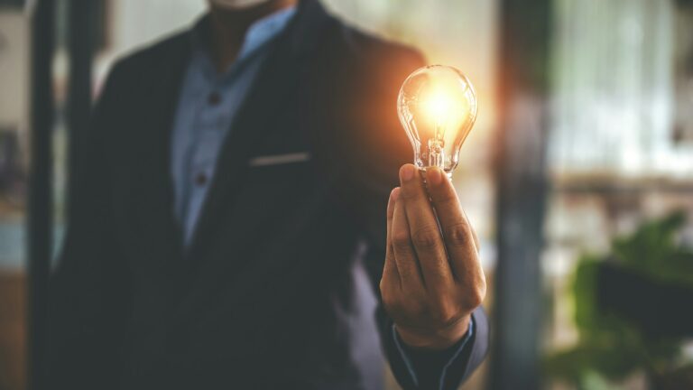 Hand holding a light bulb. Innovative concept with inspiration and energy saving concept.